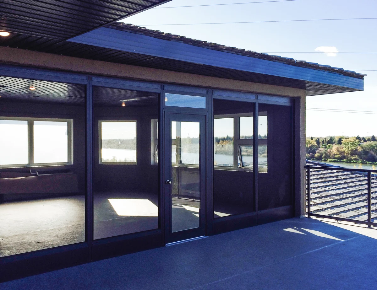 Screen room with floor-to-ceiling windows and skylights ready for upgrades and maintenance