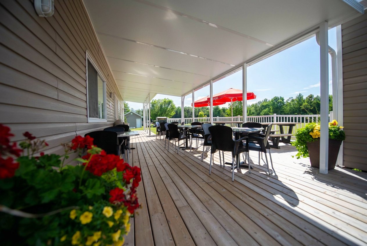 Dark-stained timber patio cover with outdoor kitchen and lounge seating