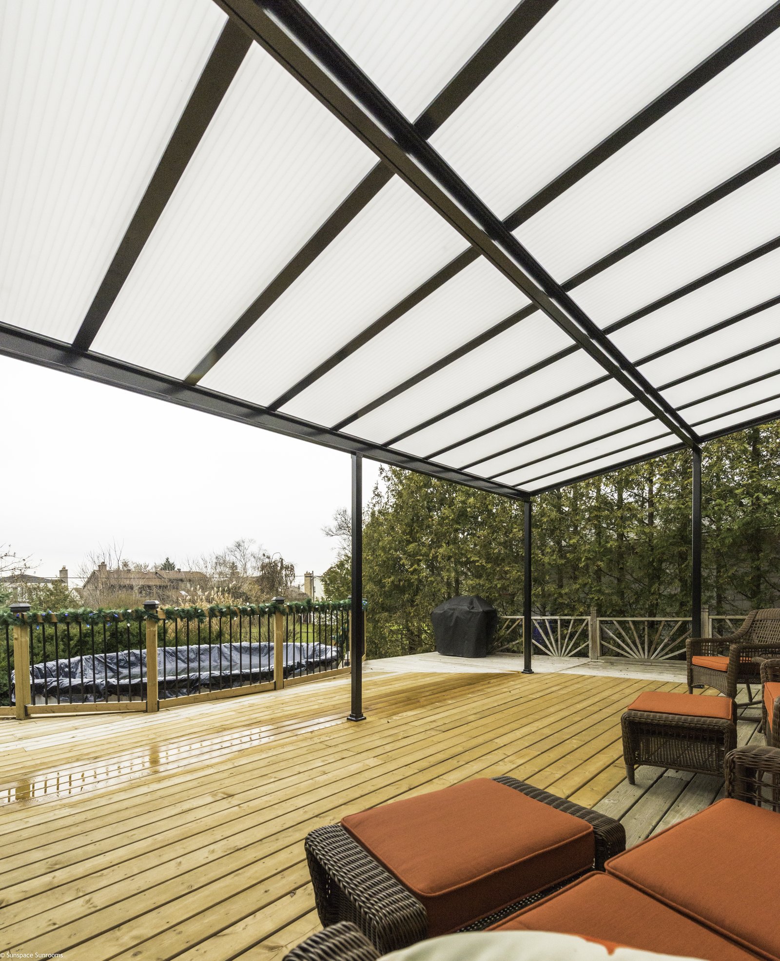 Sunspace acrylic translucent patio cover with black aluminum frame