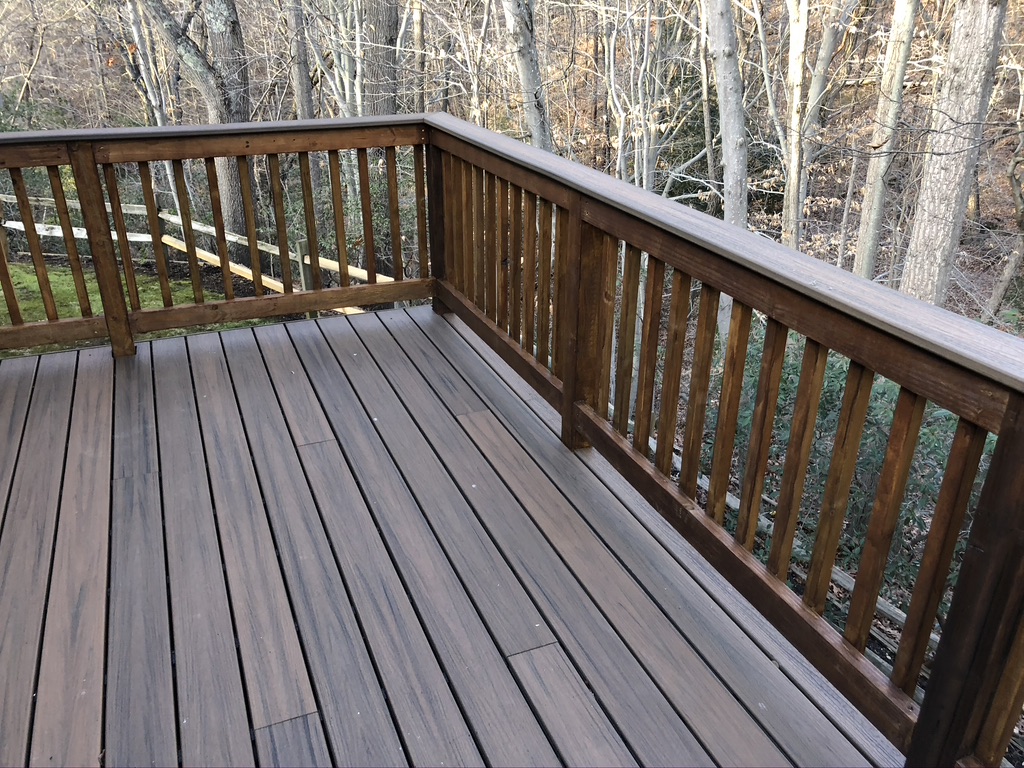 New natural wood deck with open backyard layout